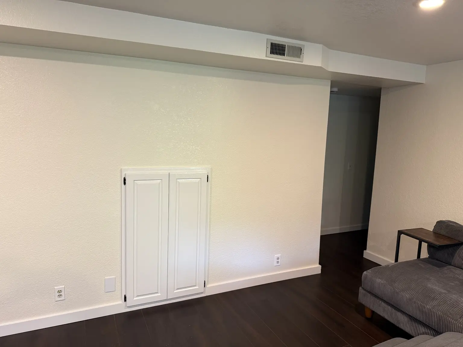 Closed white double doors concealing a built-in toy and play area in my living room