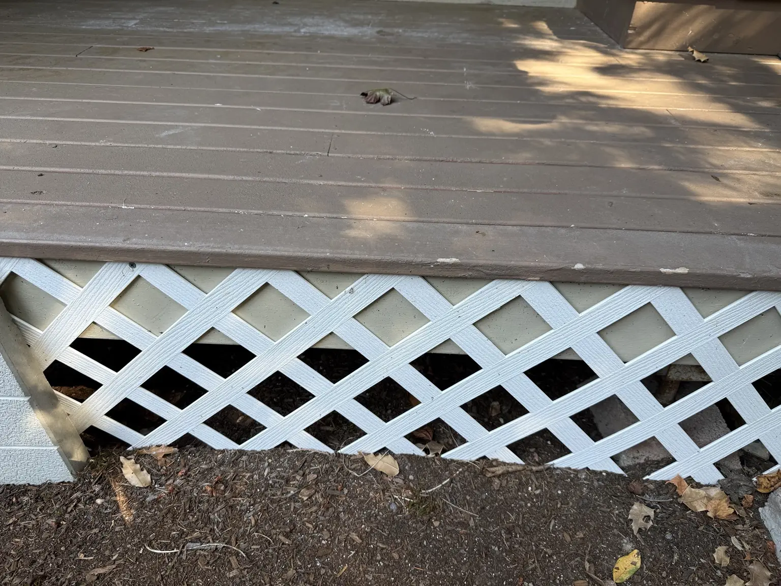 White crisscross lattice beneath the original porch