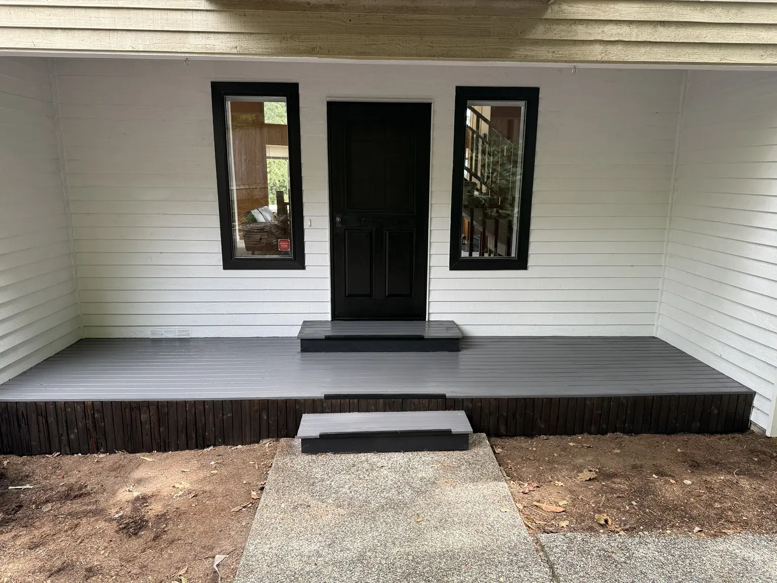 Finished white entry walls with black door and black window trim