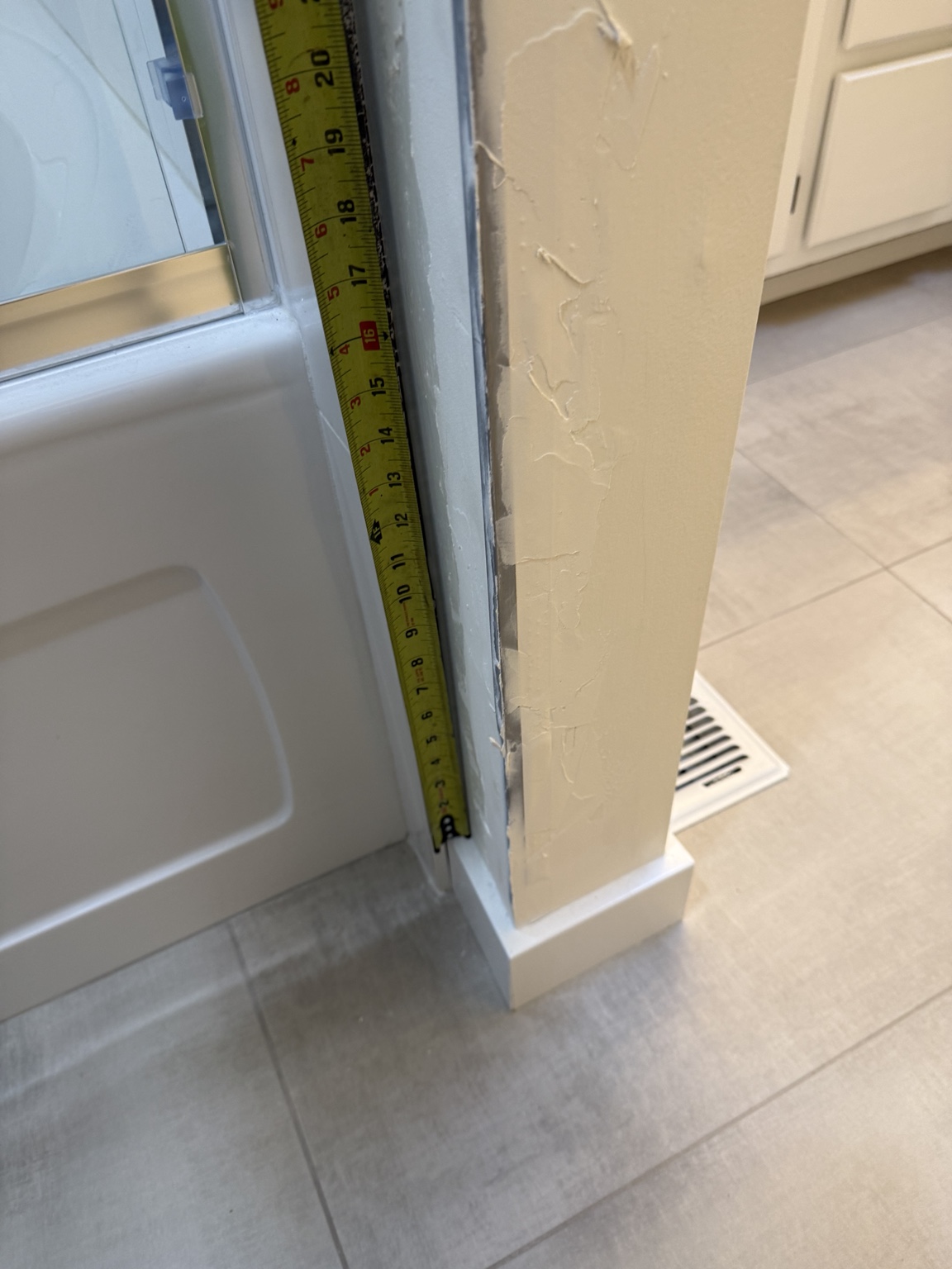 Measuring the vertical shower gap at approximately 20 inches