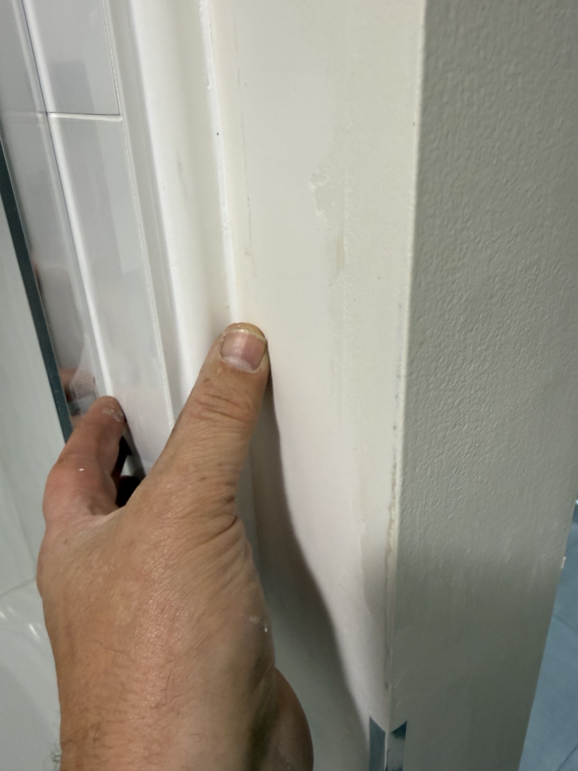 Pressing the PVC shower trim firmly into position