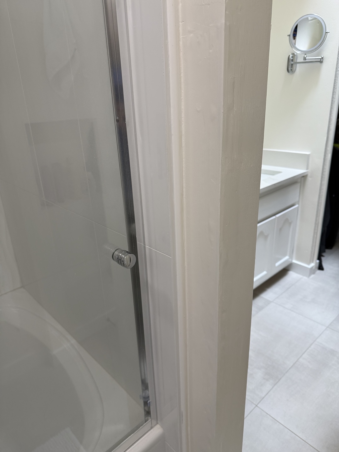 Completed shower gap repair with a clean white finished edge